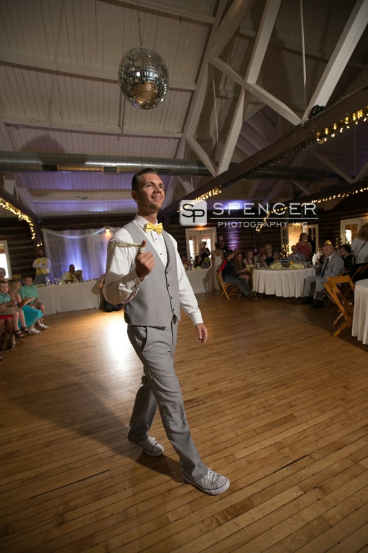  groom throwing garter at vermilion on the lake weddging reception