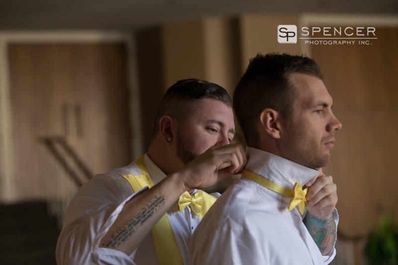  best man helping groom with tie