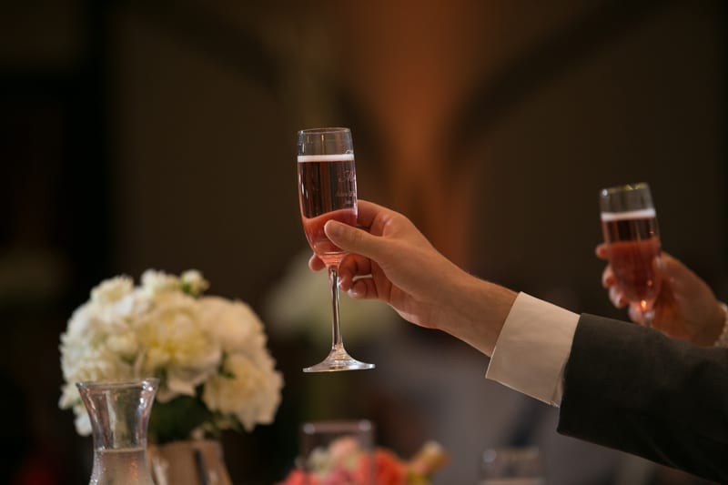 groom giving toast at wedding reception