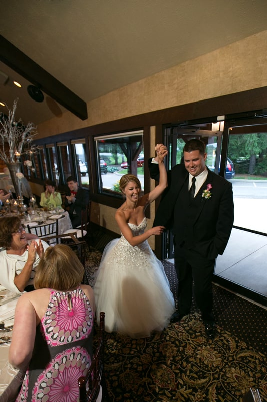 bride and groom enter their wedding reception at firestone
