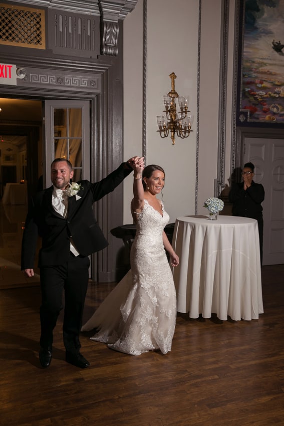 bride and groom entering wedding reception 