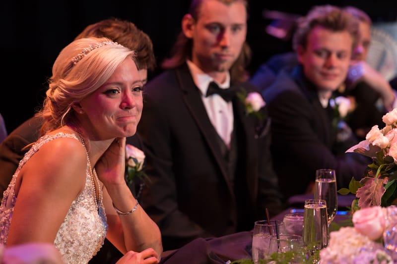 bride crying at her wedding reception