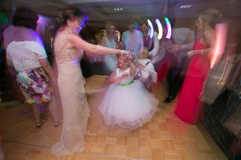 brides mom dancing with flower girl