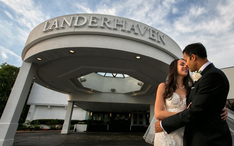 bride and groom kiss outside their wedding reception at landerhaven