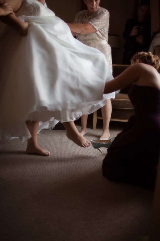 bride putting on her wedding day shoes at hyatt