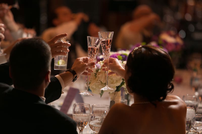 bride and groom toasting at their reception 