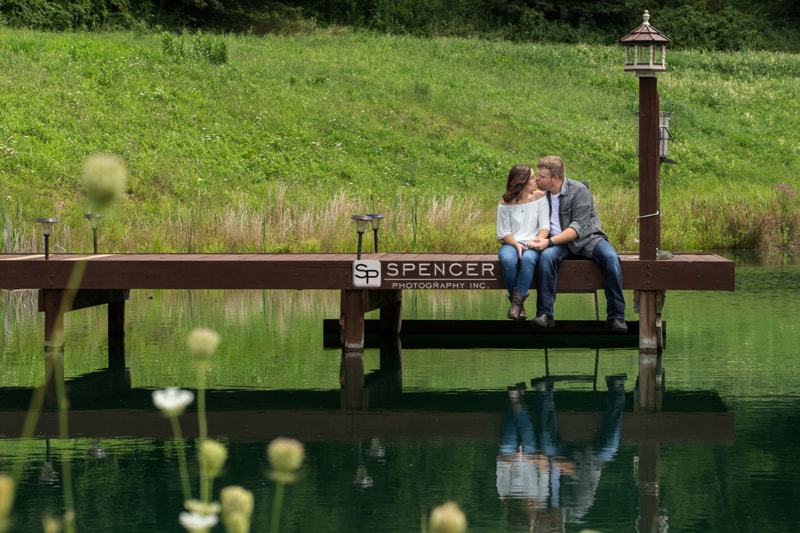 couple kissing on pond dock