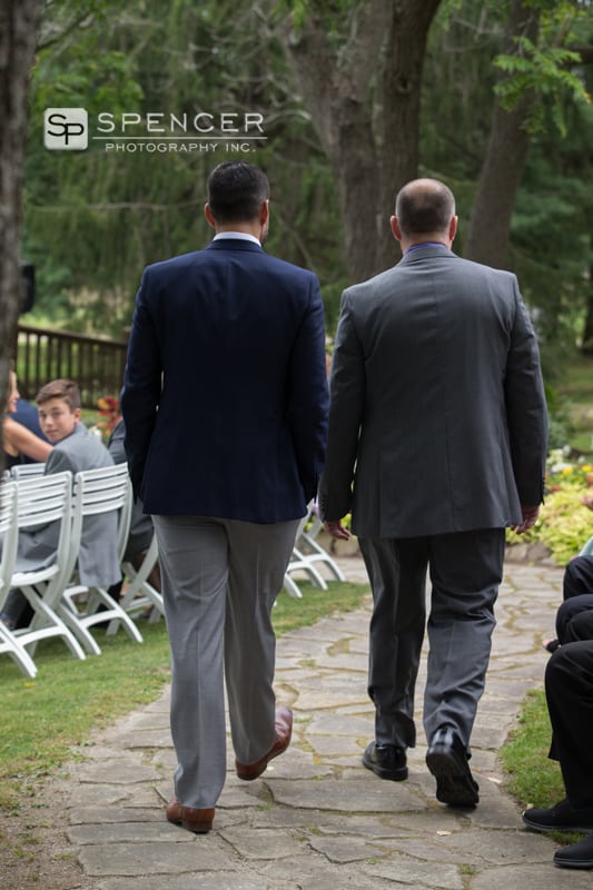 groom and pastor walking to ceremony