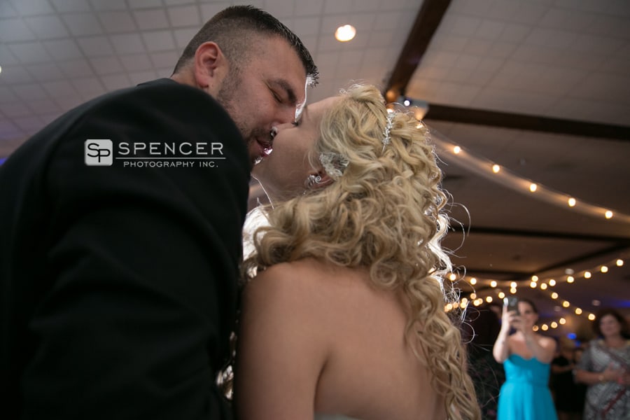 bride and groom kissing after cutting cake