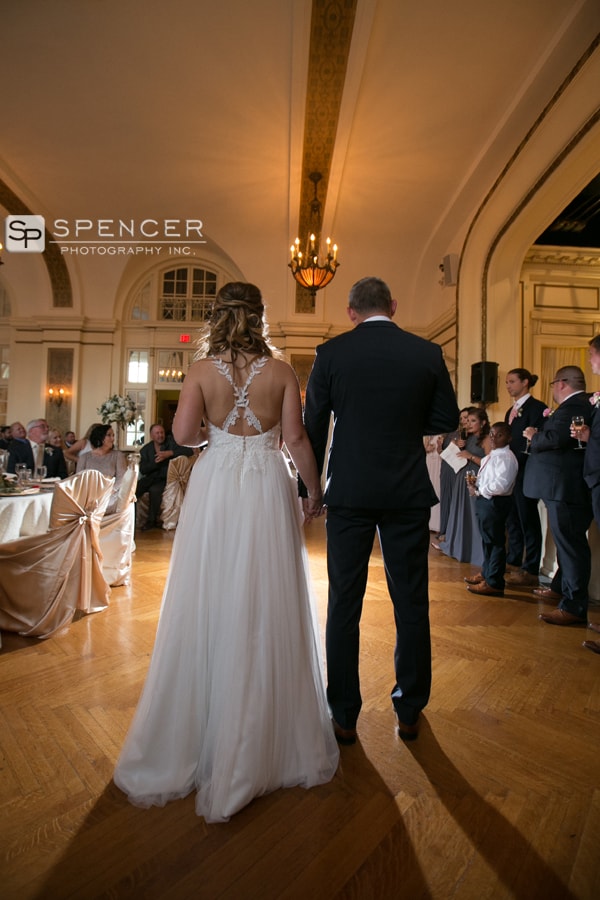 bride and groom holding hands at wedding reception at greystone hall