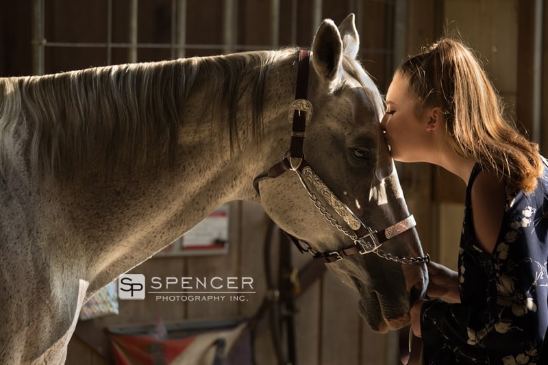 high school senior kissing a horse