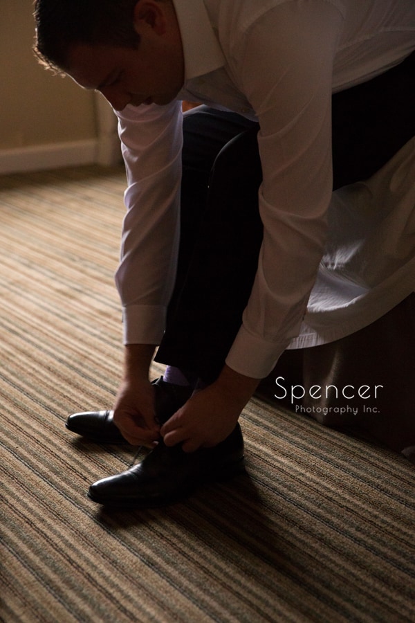  groom tying his shoe