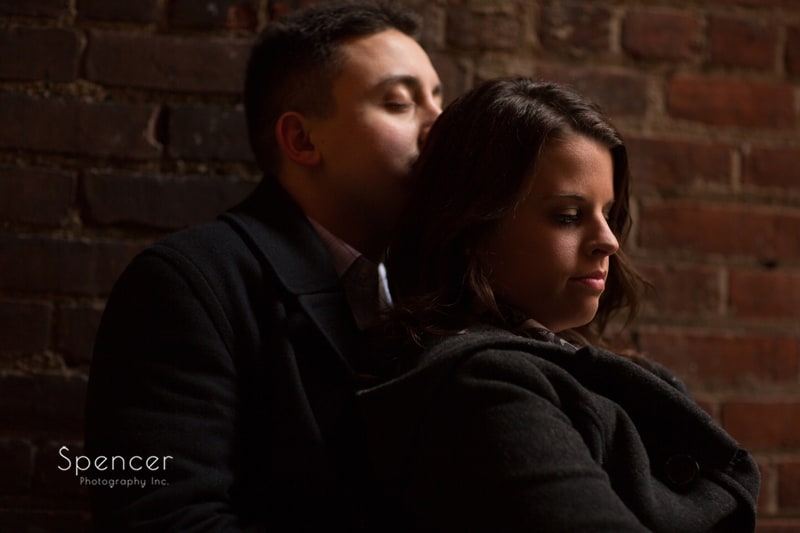 man kisses womans head in engagement picture at zocalos in Cleveland