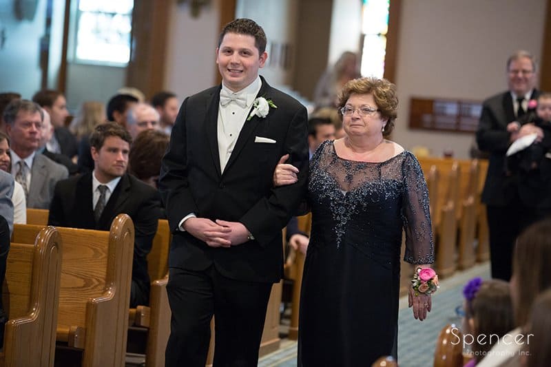 groom walking mom down aisle at Holy Rosary wedding ceremony