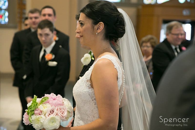 bride standing at altar of holy rosary
