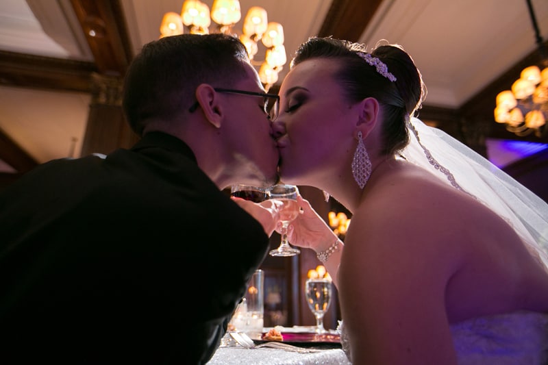 bride and groom kissing at their head table at Union Club Cleveland