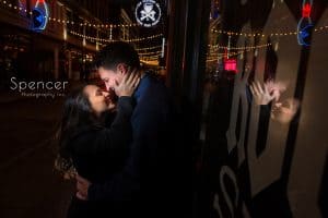 Couple hug during engagement pictures on Cleveland East Fourth Street