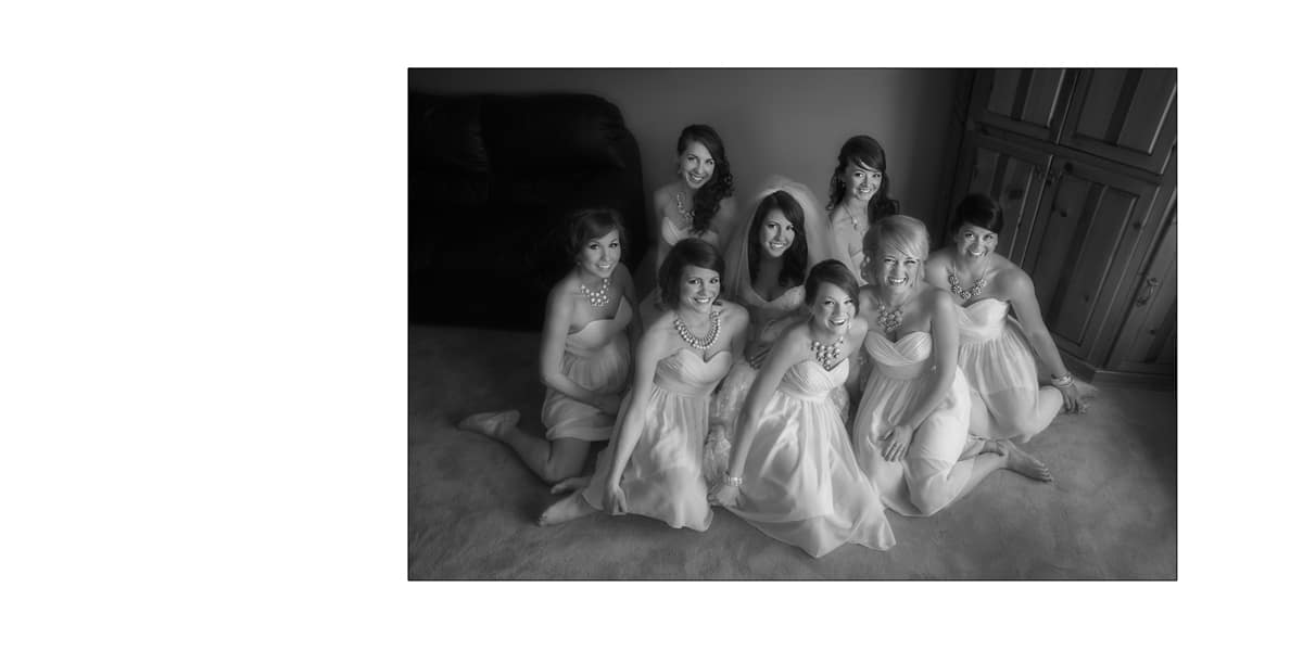 Bride sitting on floor with bridesmaids