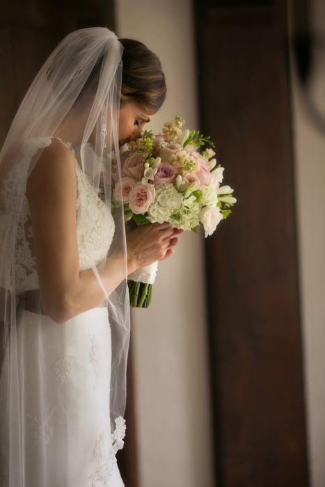 bride smelling wedding bouquet