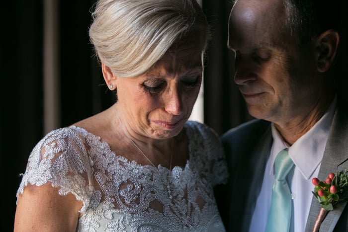 grooms parents are emotional in suite at tudor arms
