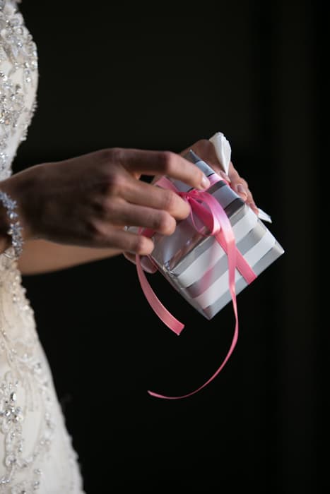 bride opens wedding day gift from groom