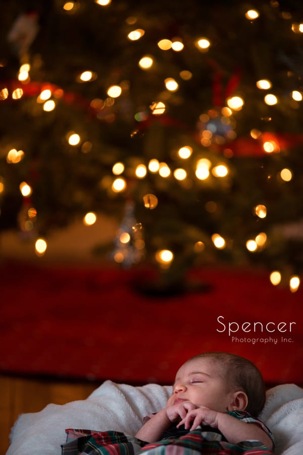 newborn baby in front of christmas tree