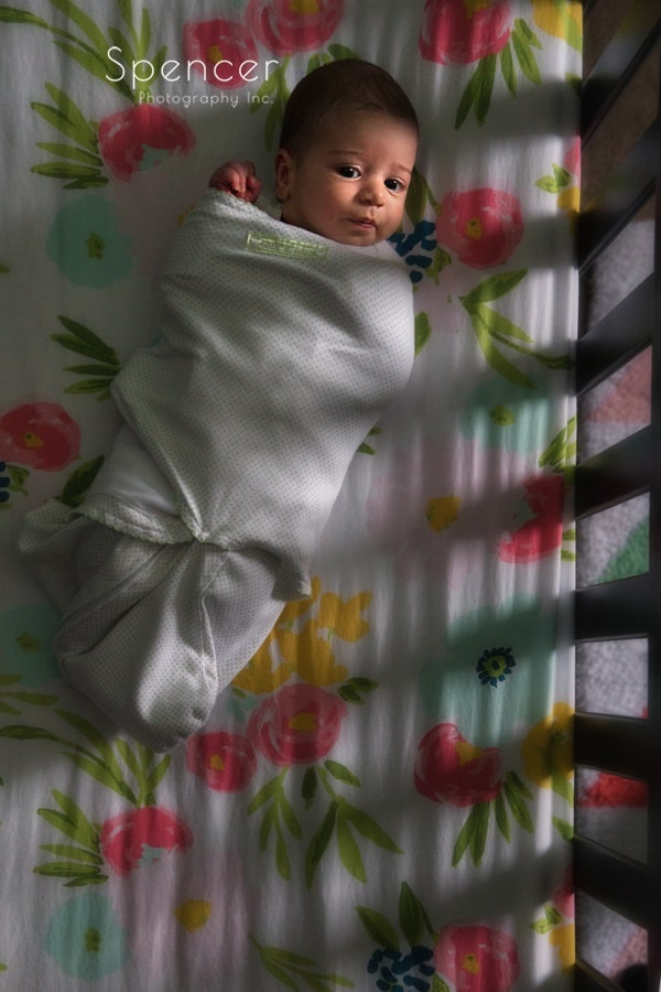 newborn picture of baby in crib