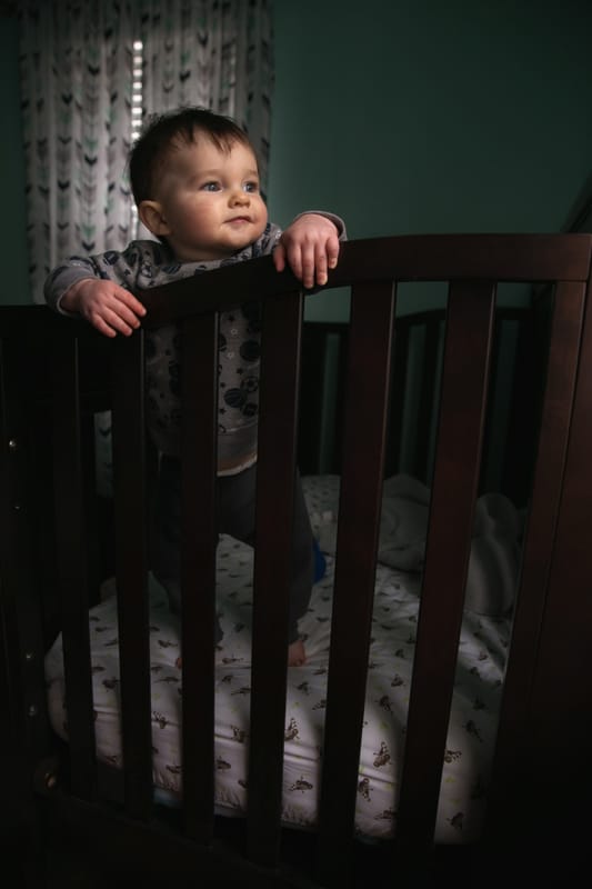  baby standing in crib