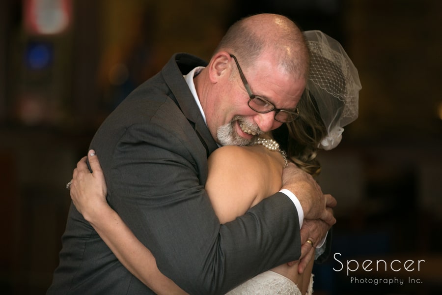 father of the bride hugs his daughter