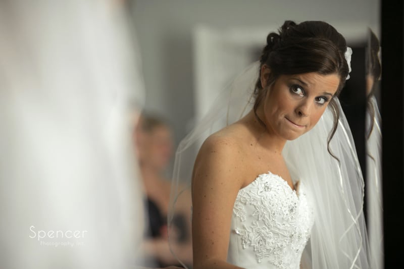  bride looking at herself in mirror