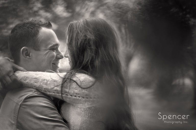 couple hugging in black and white engagement picture in Wade Oval Park