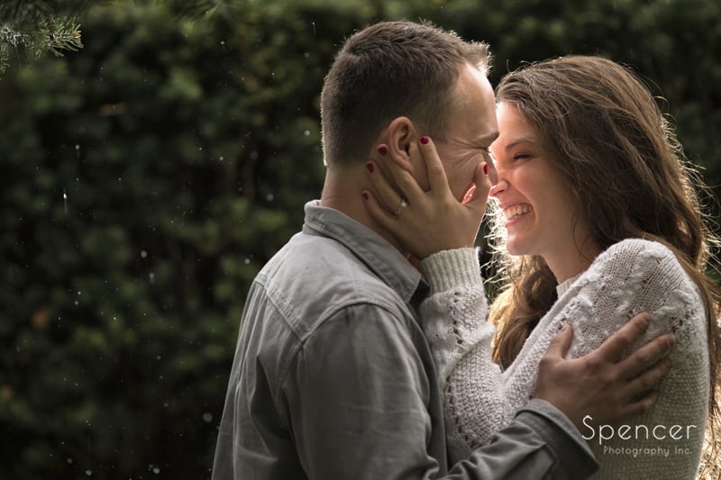 couple laughing in the rain in Wade Oval Park engagement photography