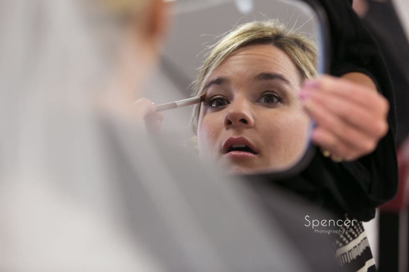 bride getting make-up done before wedding in cleveland