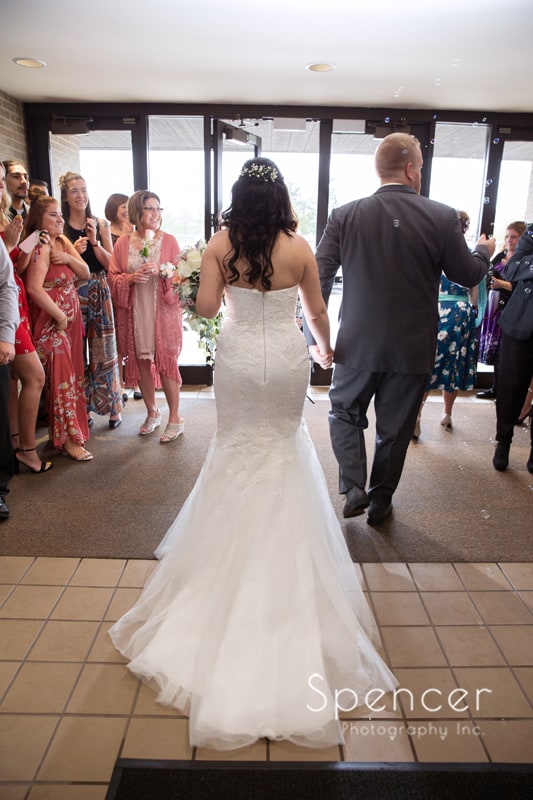  bride and groom exit their wedding cereomony in Mentor Ohio