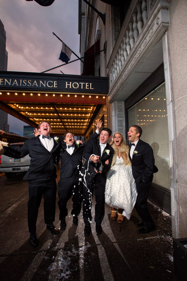 bridal party celebrate in front of cleveland renaissance