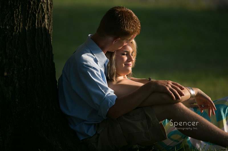 couple relaxing under a tree for their cleveland engagement session