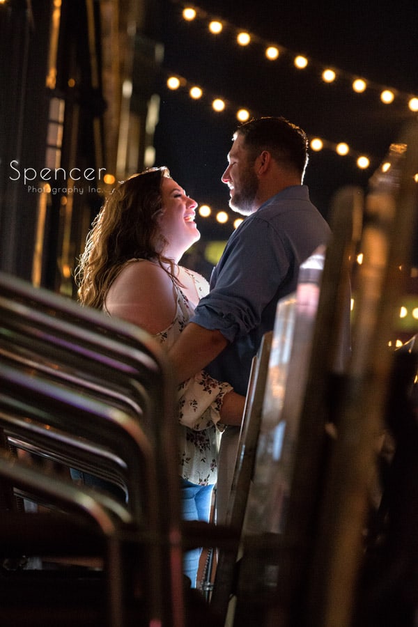 couple laughing during engagement session on cleveland east fourth street