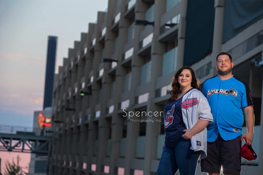 couple looking into camera during engagement pictures at progressive field cleveland