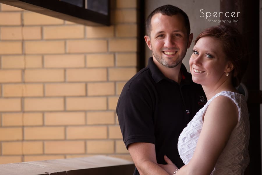 man and woman looking at camera during engagement pictures in akron