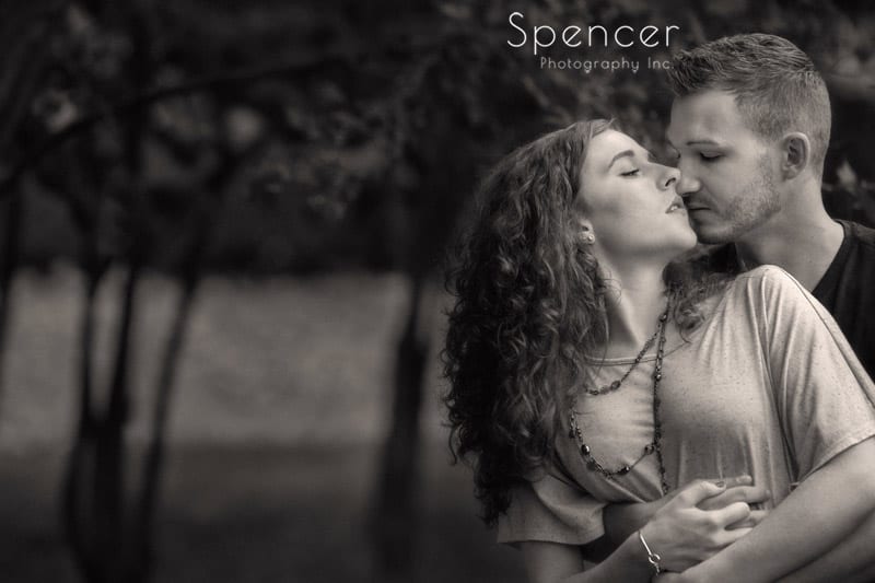 sepia picture of man kissing woman at wade oval park