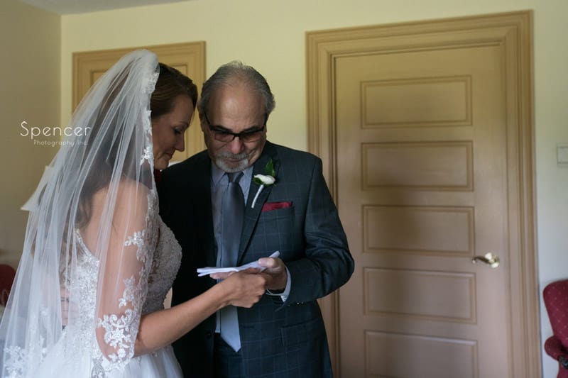 bride shares gift with father on wedding day at Portage Country Club