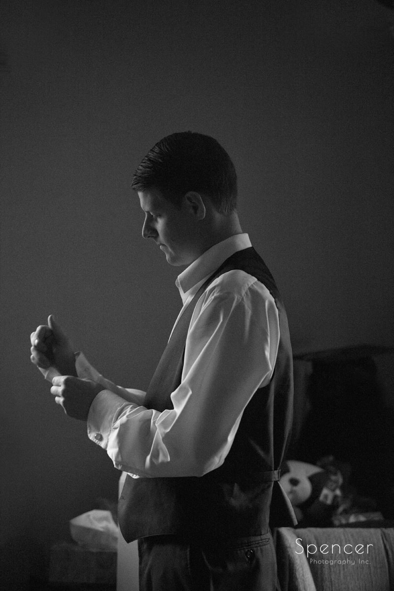groom prepping for wedding at st colman
