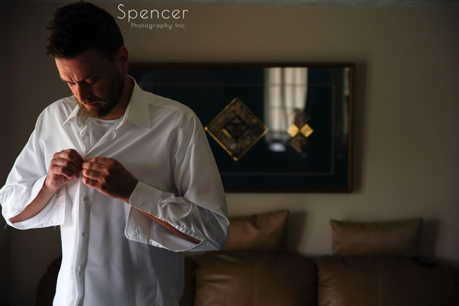groom dressing for his akron wedding