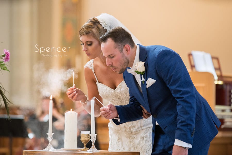  bride and groom at unity candle at St. Vincent Basilica wedding ceremony