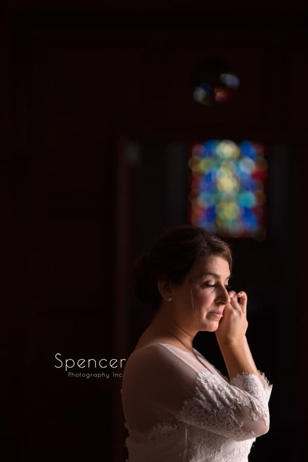 bride putting on earring at st. christopher cleveland