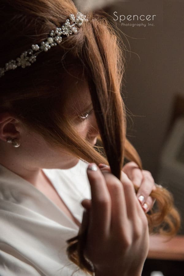  bride holding strand of hair
