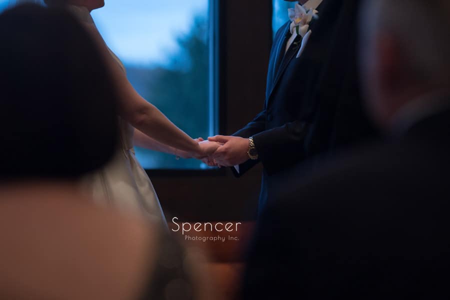  bride and groom hold hands during wedding at firestone lodge