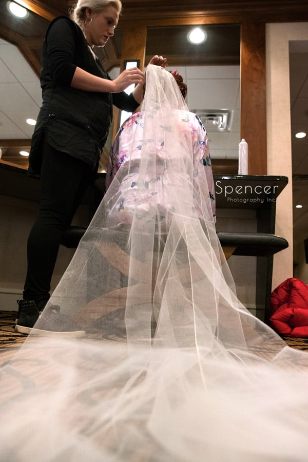 bride putting on wedding veil at Firestone