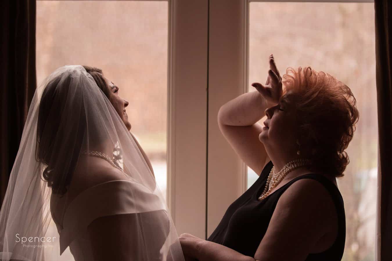 bride having fun with her mom on her wedding day