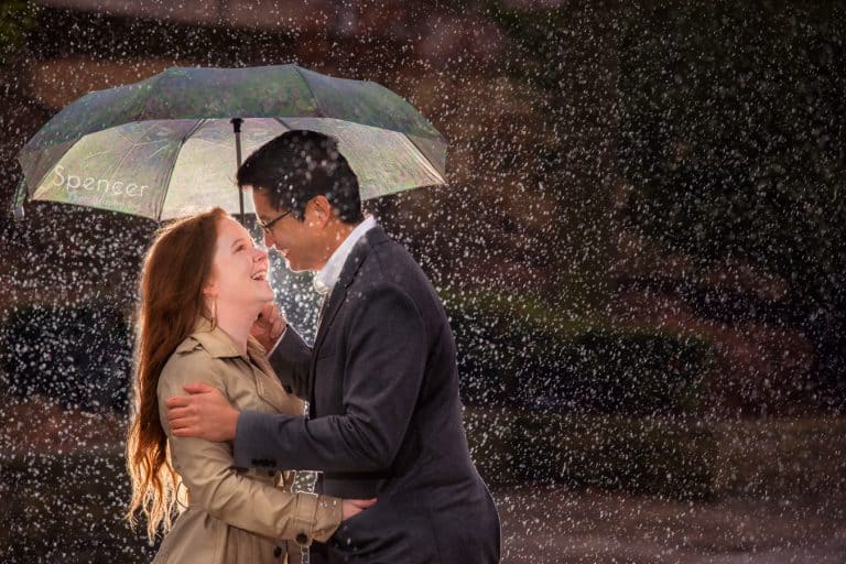 couple laughing in the rain during their engagement pictures at Cleveland Museum of Art